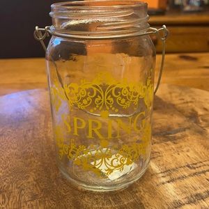 Spring labeled mason jar with wire holder.